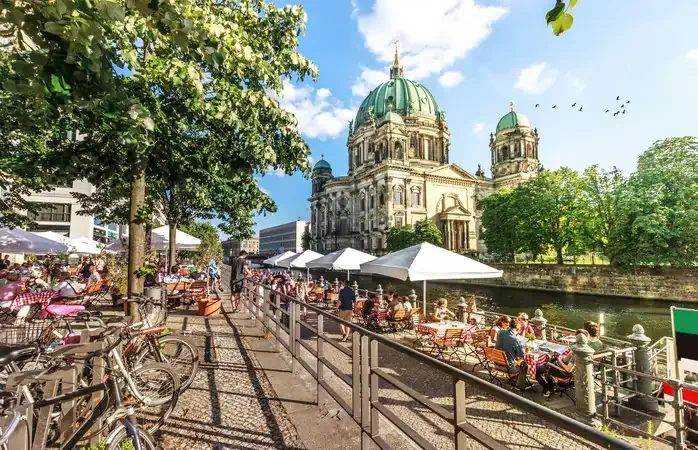 View of Spree River and Berliner Dom, Berlin, Germany.
Image taken outdoors, daylight, in summer.
Incidental people in the image.